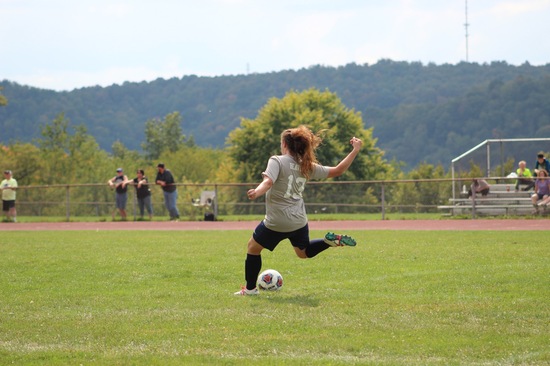 Brianna kicks the ball downfield.